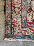 Vintage Persian Lavar Kerman rug angled view ivory ground floral field
