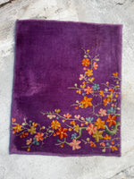 Full view of Chinese Art Deco rug with purple ground and floral motifs.