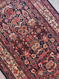 Vegetable dyed wool runner rug close-up shot highlighting hand-knotted wool pile and deep natural color tones.