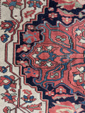 Collectible antique Persian Ferahan rug in coral red, navy, ivory, and soft blue.