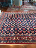Antique 1940s Persian rug with floral artwork and made with vegetable dyed wool.