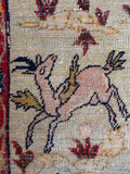 Fine wool cotton warp Tabriz rug demonstrating high knot density and durable foundational structure and showing a gazelle being hunted.