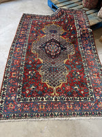 Antique 1920s Persian Bakhtiari rug with ivory field and medallion.