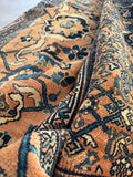 1920s Persian rug with low pile, sturdy structure, and substantial weight.