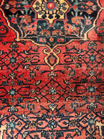Close-up of small central medallion and ornate design work on Persian Bidjar rug.