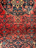 Close-up of small central medallion and ornate design work on Persian Bidjar rug.