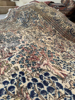 Vintage Persian rug with Birds of Paradise and cascading botanical art.