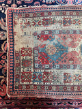 Vegetable-dyed antique Caucasian rug featuring vibrant aged earth tones and traditional geometric motifs.