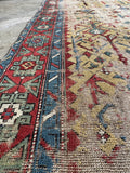 Hand knotted Caucasian runner, antique wool rug with tribal village motifs, vegetable dyed wool, and a naturally worn low pile.