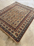 Antique handwoven tribal rug from the Caucasus mountain region near the Caspian Sea.