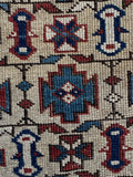 Close up of vintage Caucasian Shirvan rug with worn in character and stout wool construction.