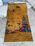 Small Art Deco rug with open field design in yellow, blue, and burgundy.