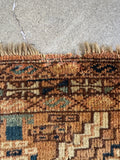 Authentic antique Turkmen textile close-up view showing one tiny part of fringe missing.