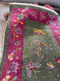 Vintage Art Deco wool rug featuring a perched bird, butterfly motifs, and botanical vines.