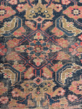 Antique Herati pattern close-up focusing on the traditional water garden fish and floral design elements.