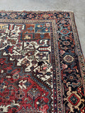 1920s Persian Heriz rug 10x13 ivory spandrels tribal geometric design.