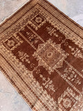 Vintage hand knotted Indian wool rug with authentic antique patina and natural color variation.