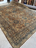 Antique 1920s Persian Kerman rug with camel and blue color palette.