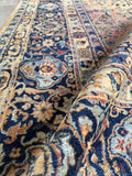 Persian Kerman rug navy border ornate pattern close up.