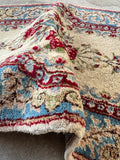 Small floral Persian wool rug with a plush surface and romantic botanical design.