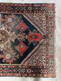 Kurdish handmade rug with vibrant spandrels and traditional tribal motifs.