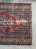 Hand-knotted Persian Mazlaghan rug showing geometric central medallion and border.