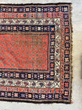 Persian tribal area rug featuring traditional paisley boteh motifs and intricate multi-layered borders.