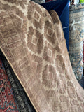 Earth tone tribal runner with soft brown and sand hues.
