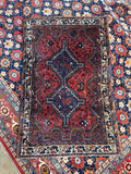 Hand-knotted Persian tribal rug measuring 2'10 x 4'3 for small entryways or accent areas.