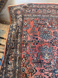 Antique Persian Dargazine Rug in a rare coral pink field with navy, ivory, and blue floral sprays, handmade c. 1930s.
