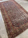 Antique Persian Ferahan carpet. Hand knotted circa 1900 wool rug with floral border bands, low pile, reinforced areas, and remarkable antique character.