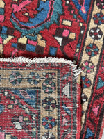 Underside view of vintage Persian gem rug with colorful tribal character.