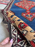 Narrow Persian hallway rug with low pile and stout hand-knotted construction.