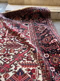 Antique Northwest Persian Heriz rug with bold angular motifs and healthy wool pile.