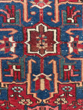 Close up of antique tribal Persian rug with central medallion and strong geometric artwork.