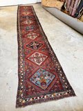 Entire Heriz runner showing geometric layout and color variation.