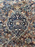 Closeup of central motif in 1920s Persian Kerman rug.