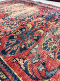 1920s Persian Lilihan rug showing authentic age-faded patina and scattered wear throughout its low pile.