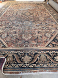 1930s antique Persian area rug featuring a large central geometric medallion on low-pile hand-knotted wool.