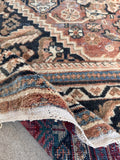 Vintage hand knotted area rug back side view displaying authentic coarse Persian weave structure.