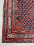 Antique Persian Malayer rug with navy field, repeating boteh motifs and tribal animal details.
