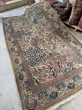 Vintage 1940 Persian rug featuring Birds of Paradise on an ivory ground.