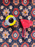 Hand knotted Tehran rug close up with duck tape and tape dispenser for color scale reference.