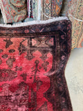 Corner view of heavy full pile wool Persian rug with cushioned underfoot feel and high depth color.