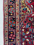 Detailed view of dark navy floral chain border and saturated color story.
