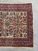 Antique Persian rug with one end carefully restored by reweaving.