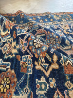 Folded view showing weave pattern and cool tone and earthy color palette.