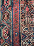 Persian runner showcasing cool blues, greens, and warm reds.