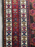Detail of cheerful floral chain border on Kurdish tribal runner.