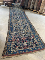 Antique 1920's Persian runner showing the end with the crimson wool woven into the design.